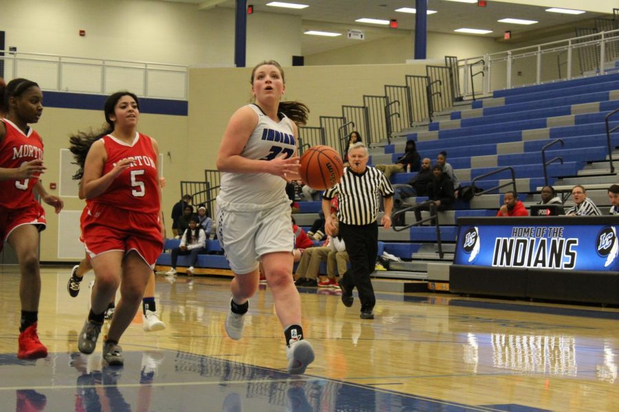 Addison Graf (9) runs the ball down to LC’s side of the court.  The ball was passed to one of Graf’s teammates.