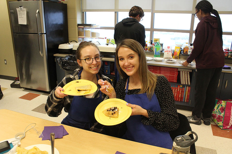 Claire Bandstra (12) and Allison Centanni (12) pose with their finished crepes. The girls were the first to finish making the desserts.