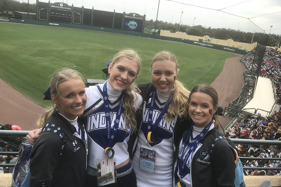 The four seniors of the Varsity cheerleading team smile in front of The Stadium at ESPN Wide World of Sports. The girls kept good spirits even after hearing that they did not make it to the next round.