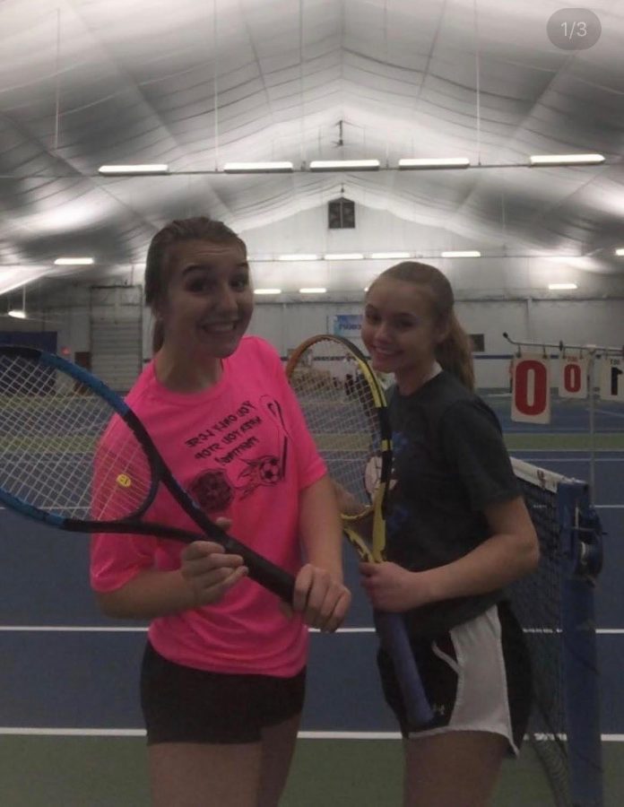 Maya Gorney (9) and Maya Trivunovic (9) smile as they hold their tennis rackets.  They both met up at Matchpoint Tennis and Fitness Club to practice before the high school season was supposed to start.