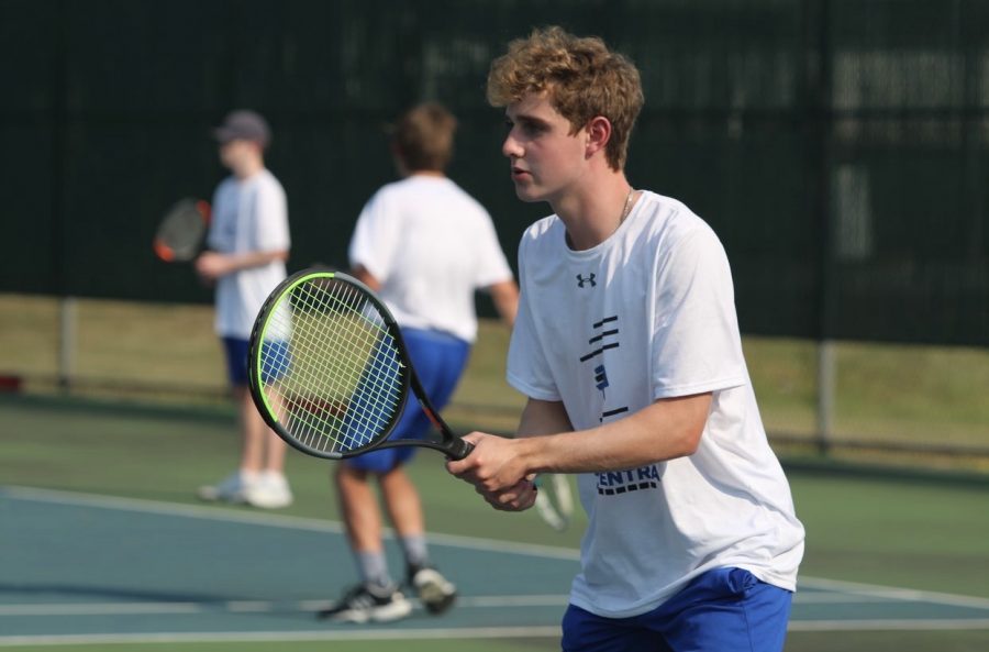 Kyle Kennedy (11) looks determined while he waits to hit the ball back to his opponent.  The boys tennis team won against Highland with an overall score of 5-0.