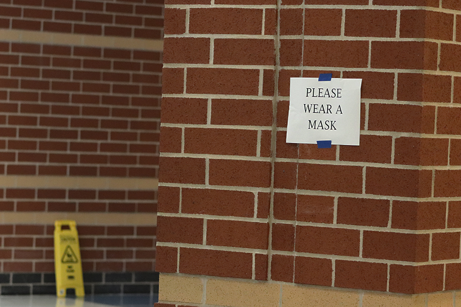 A Please Wear a Mask sign hands in Main Street in the high school. There are signs up all around the school reminding students and staff to social distance and wear their masks. 