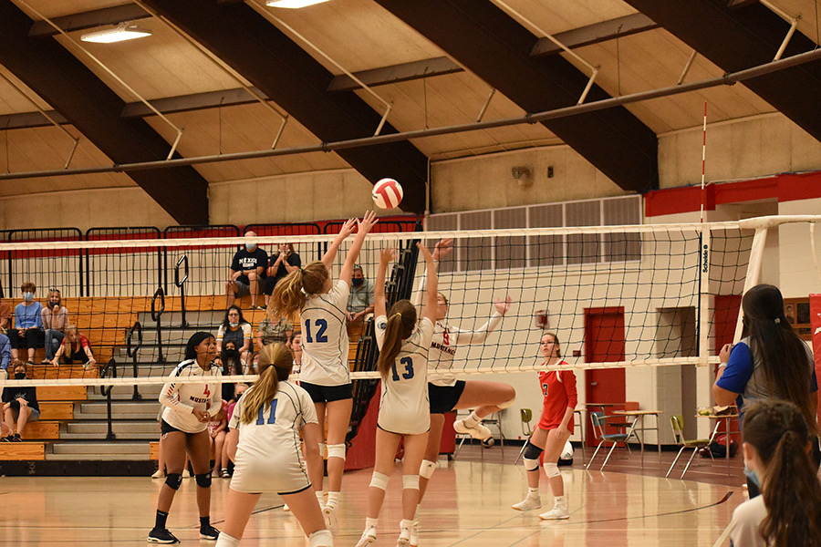 Teagan Thomsen (9) and Alex Jelcic (9) go head-to-head with Munster at the net. They worked together to prevent Munster from scoring yet again another point.