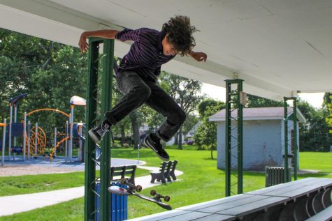 David Fritz (9) kickflips on a park table. He landed the trick successfully. 