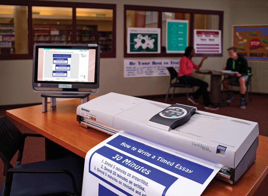 A poster exits the printer while sitting on a desk. Many posters such as these are made using printers in graphic design.
