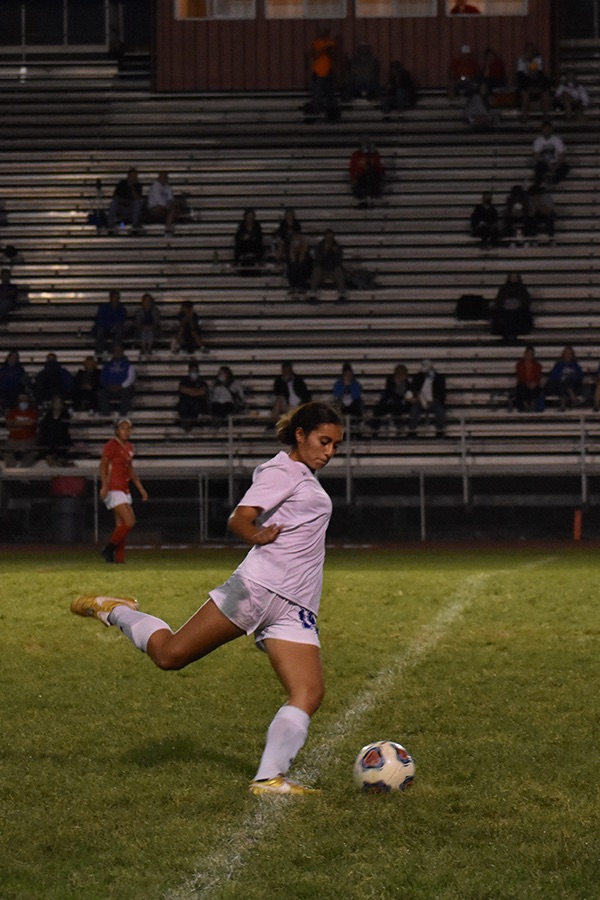 Simone Castaneda (11) kicks the ball down the field. She played an important part in keeping the ball away from their goal. 