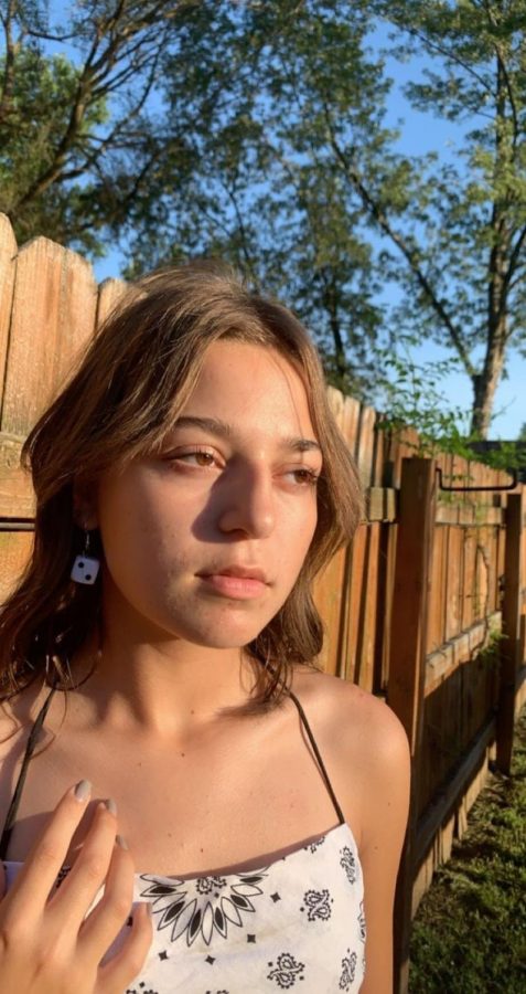 
Addyson Popoca (10) models a pair of custom earrings she created. This pair and many other custom-made jewelry items can be found by searching huac0ra on Instagram. 
