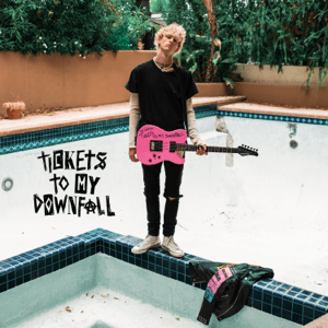 Machine Gun Kelly poses for his new album “Tickets to My Downfall”.  His new look of punk-pop added to the atmosphere of new hits.