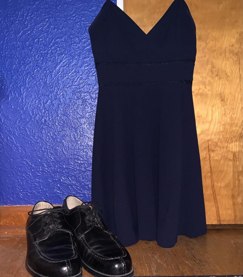 A blue dress hangs above a pair of men’s dress shoes. Both of these items of fashion represented the stereotypical expectation of what girls and boys should wear; Harry Styles has embraced both sides of fashion.
