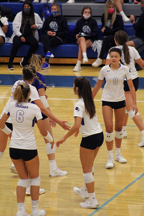 The girls come together after scoring a point. They kept their spirits high during the game.