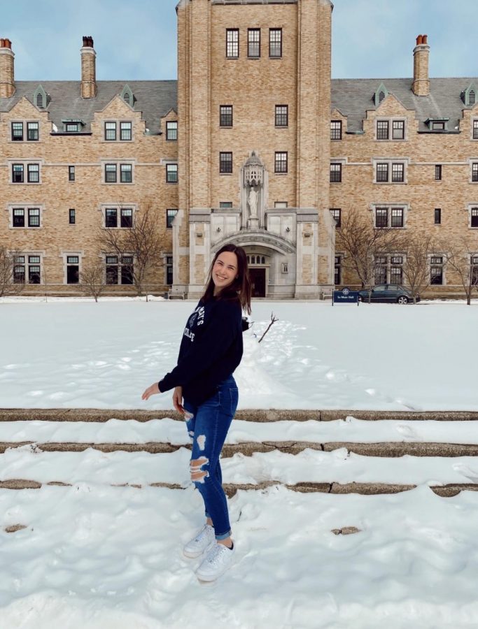 Grace Renschen (12) poses in front of St. Marys College.  She recently committed to play softball at St. Marys.