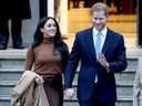 Prince Harry and wife Meghan Markle smiled at the paparazzi. The two were walking hand in hand. 