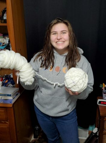 Karah Sikora (12) holds up her soon-to-be record-breaking crochet chain.  She has been working on it since 5th grade.