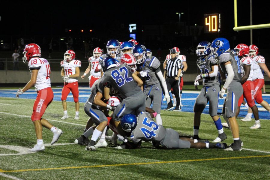 Kameron Gethers (11) gets trapped under the pile as Nick Engelhaupt (12) and other players tackle a Crown Point player trying to run the ball. LC’s defense was a relatively strong force to be reckoned with during the tough game. 
Photo by: Alison Irace