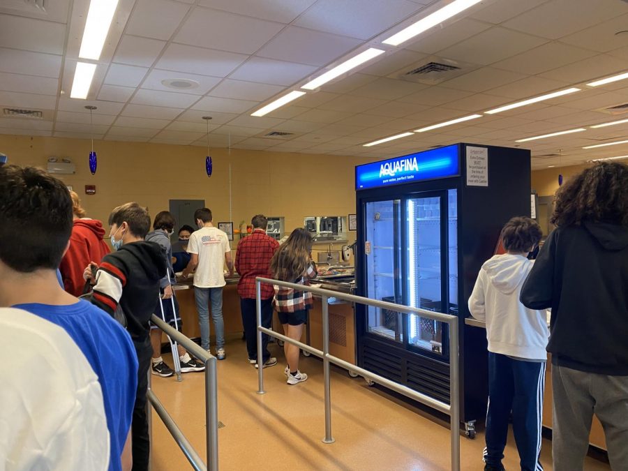 The inside of the serving area is filled with students waiting to be served.  Along with free lunch, students can pay a fee for water, chips or other snacks.