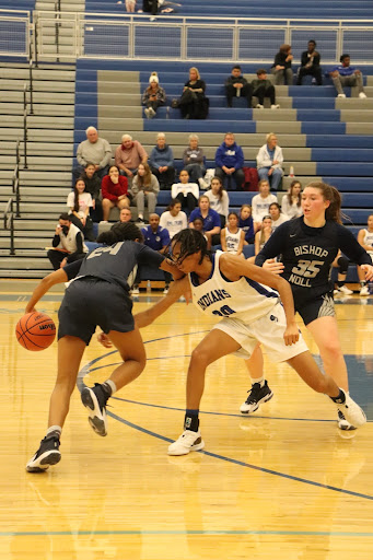 Essence Johnson (12) attempts to get the ball away from the competitor. She went on to score later in the game.
