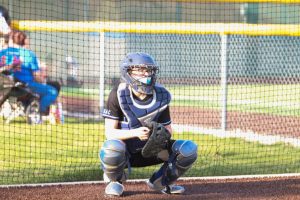 Paige Reitz (12) is catching a softball during a warmup. This was her third season on the team. 