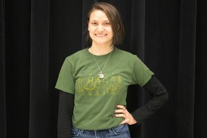 With her hand on hip, Chloe Baisa (12) poses in the choir room. She started her fine arts career when she was young. 