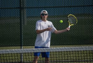 Watching the tennis ball cross the court, Alex Wroblewski (10), hits it back to his opponent, scoring a point. 