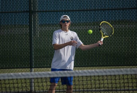 Watching the tennis ball cross the court, Alex Wroblewski (10), hits it back to his opponent, scoring a point. 