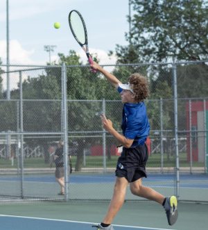 Returning back a serve is Jeremiah Kypers (11). He was determined to win the match.