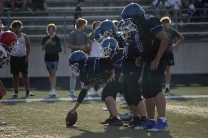 The team lines up against Munster and gets ready to play the ball. Colton Mynes (9) throws the ball back to the quarterback and runs the ball. 