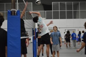 Ryan Behm (11) watches his teammate pass the ball backwards. Each intramural team competed in matches of three sets.