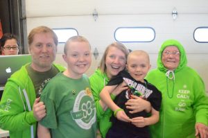 My family stands together after my sister and I shave our heads for the first time in 2014. Together we raised $5,456.
