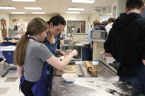 Natalee Stevenson (9) and Brayden Cooper (10) sprinkle sugar on the heart. It was made out of leftover pizza dough, making an additional dessert.