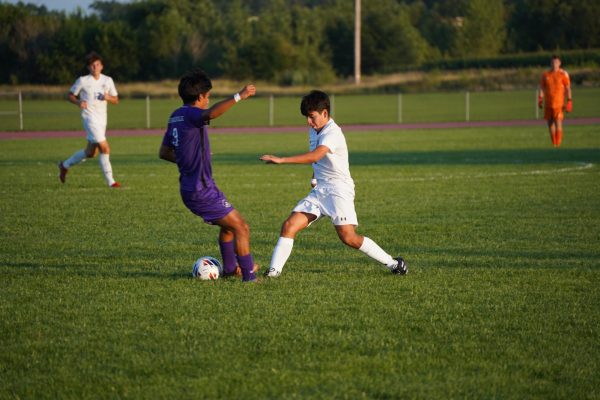 Weaving through his opponents, Adres Ruiz-Avila  (11) dribbles up the field. Keeping a strong offense, he passed to other teammates.