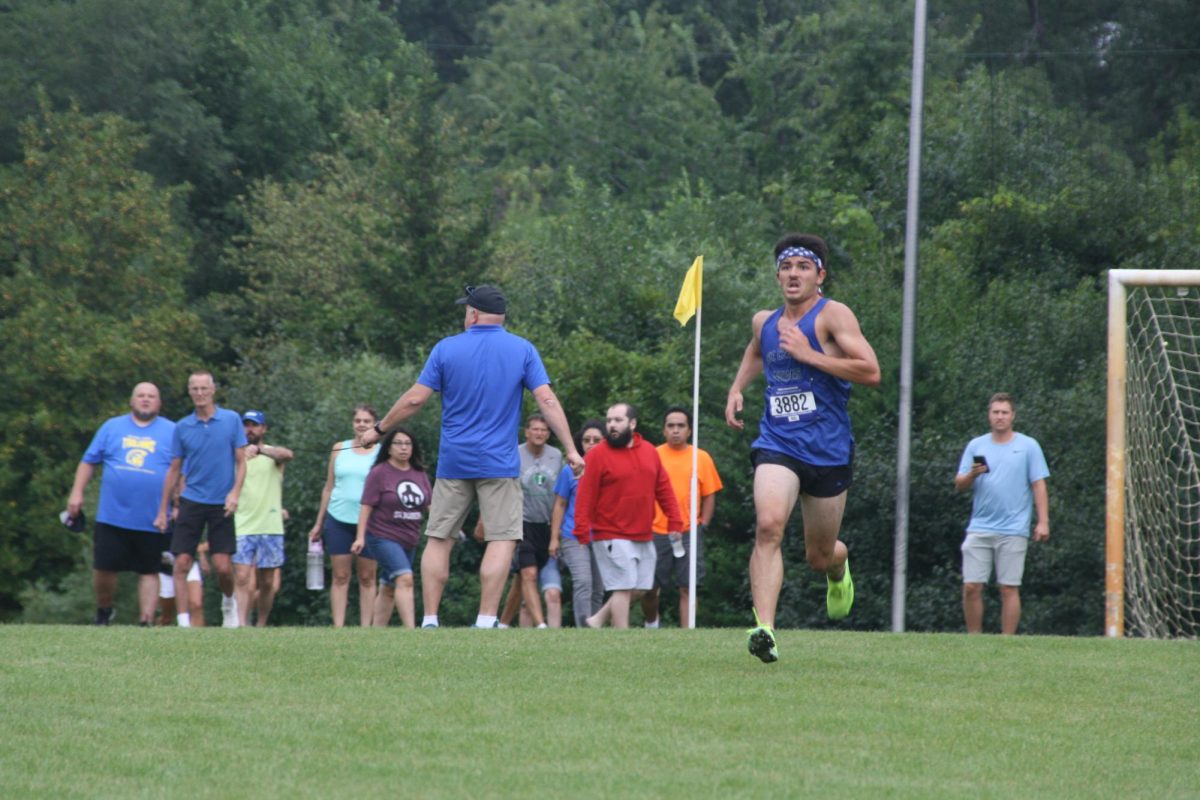 Coming around the final corner, Benjamin Perschon (10) begins to sprint as the finish line comes into sight. He finished in second place with a time of 15:43.78 and broke the sophomore record.
