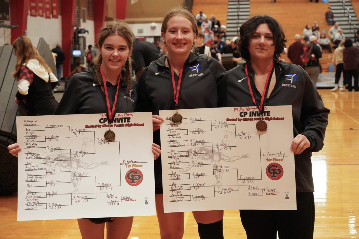 Posing for the camera, the girls wrestling team shows off their awards. First places were won by Elly Janovsky (12) and Reese  Kasprzak (11).