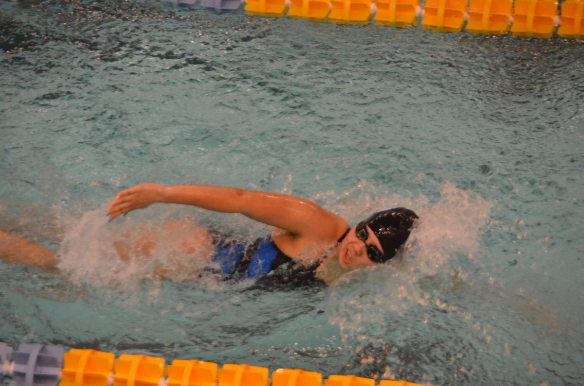Swimming in the water, the swimmer strives forward as she tries to dive in front of the other swimmers. The athlete went early to practice for her meets and saw the impact it made on this meet. “This season I see the team placing third for the DAC,” Tara Schassburger (11) said. 
