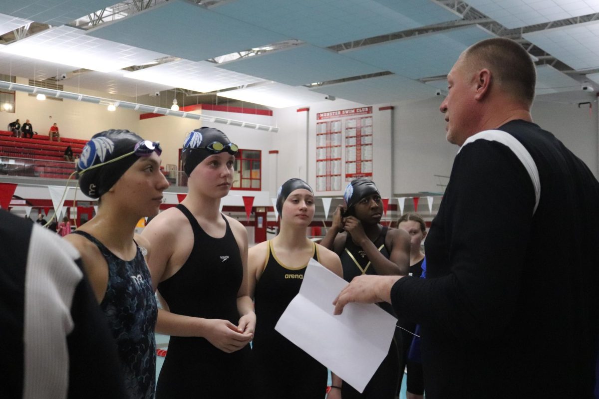 Before the meet, Coach Jeff Kilinsky gives his swimmers a pep talk and some words of motivation. The girls swam their meet and most got high enough scores to continue on this season. 