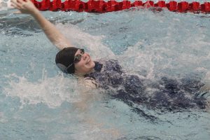 As the swimmer does backstroke, she keeps motivated while in the water to keep pushing through. The swimmers smiled through their events as their friends and coaches cheered them on. “My favorite part about swimming at Lake Central is getting to know everyone better through the early morning and afternoon practices spent together as well as cheering everyone on at meets,” Isabelle Marcotte (11) said. 