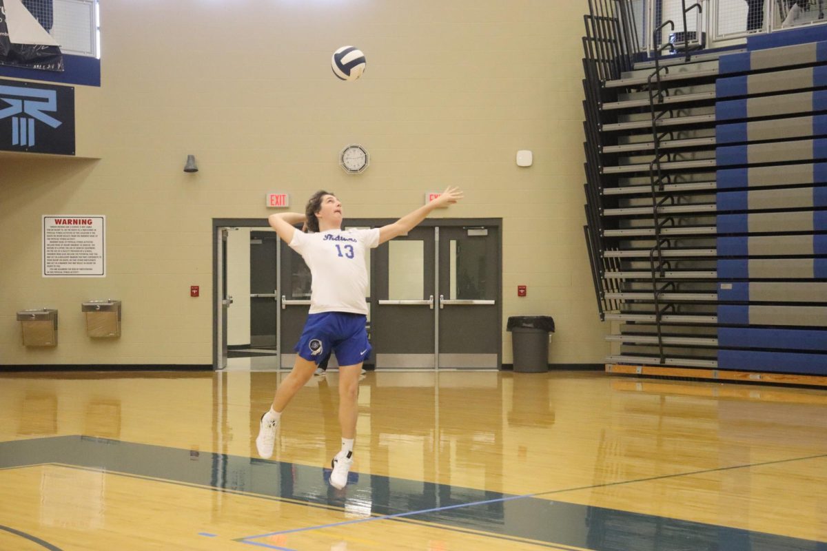 Serving the volleyball, Braedon Cook (9) launches the ball over the net.The Lake Central Boys Volleyball team worked hard and won the March 9 game against Merrillville. 
