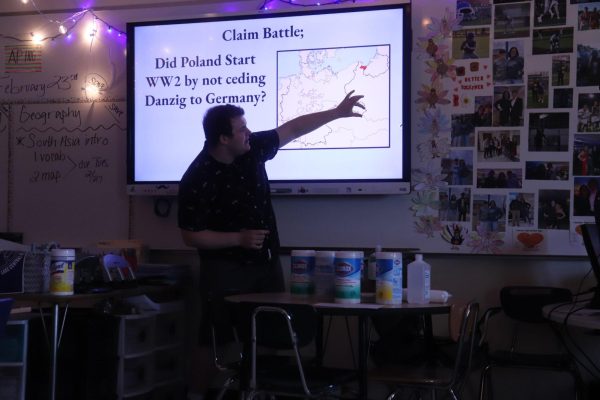 Standing in front of the class presenting, Leo LaVoie (12), discusses different topics about World War 2. As club president, he leads the club in discussions about what happened on that day in history.