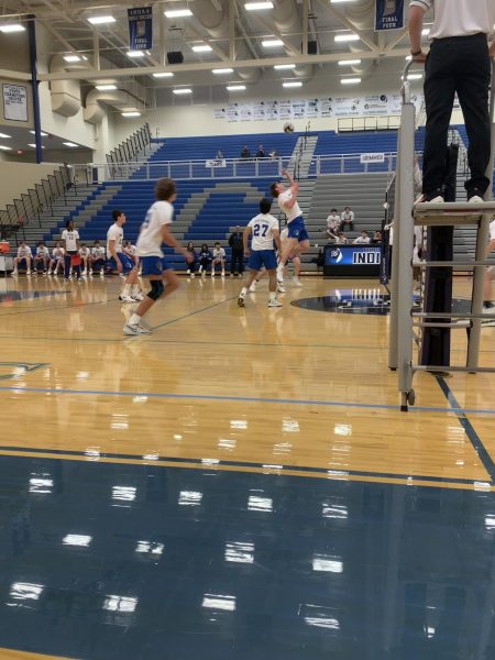 During the second set of the varsity match, Elliot Lawson (11) taps the ball over the net. Lake Central won this set against Michigan City. 