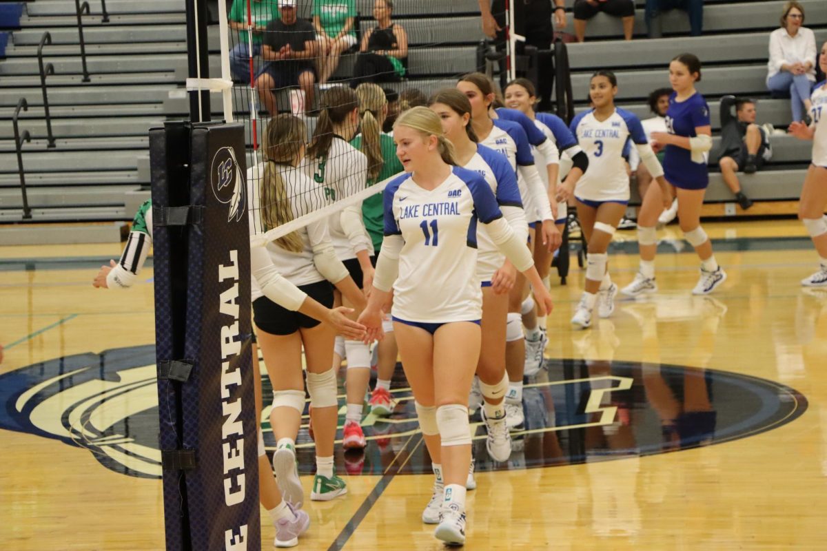 Starting the chain, Abigail Moore (10), high-fives the opposing team. This gesture may seem small, but it has a big impact on their performances. “It is really important to high-five with the other team before the game because it gets us hyped up. It also promotes good energy going onto the court,” Moore said.  