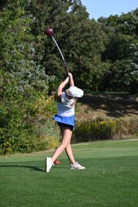 Finishing her first swing, Maya Parks (10) watches where her shot lands. After Parks realized she enjoyed golf, she joined the team a few years after. “I joined the golf team because I really enjoy the game and it challenges me everyday. Golf affects me positively by improving my ability to control my emotions. On the course it is just you out there and there are times you find yourself feeling lost. I try to show my commitment to the sport and my team by putting in work at practice daily and spending time by myself to improve my game,” Parks said.