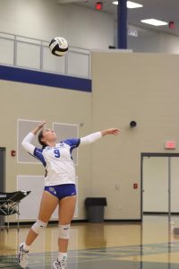 Up to serve, Lily Barth (11) looks at the ball ready to swing. She jumped up and her serve went over the net. “We were just kind of playing frantically. I think the communication could’ve been better at the beginning, but I think we pulled it together and we came out with the win,” Barth said.