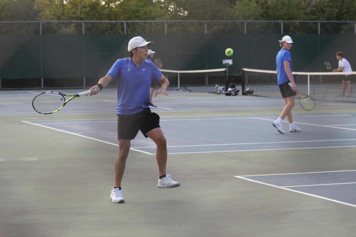 Stepping back to hit the ball, freshman varsity player Joseph Devine (9) works hard to win the match. Devine got a pep talk from his coach with some advice and motivation. “I started playing tennis for physical therapy when I broke my knee. I wanted to join the Lake Central tennis team because I thought that it would be something that I would enjoy and to be more physically active. I always give my all during matches even if I don’t feel my best. I have had a back injury and a wrist injury but I try to not let that hold me back,” Devine said. 